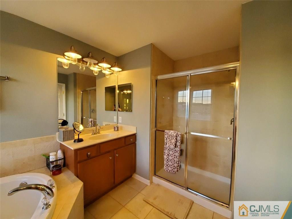 4 Raritan Reach Road, Unit 1002 South Amboy, NJ 08879 - Photo 10 of 19 a bathroom with a double vanity sink mirror and shower