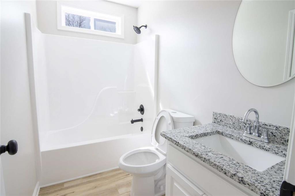 824 Eastmont Road Winder, GA 30680 - Photo 14 of 35 a bathroom with a granite countertop sink and a mirror