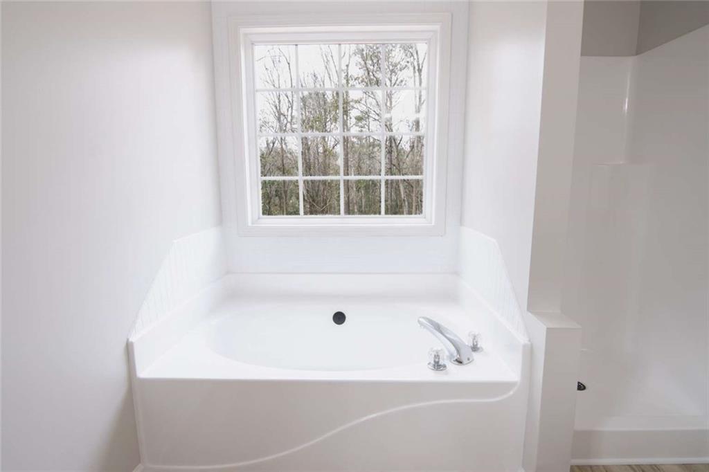 824 Eastmont Road Winder, GA 30680 - Photo 16 of 35 a white bath tub sitting next to a window
