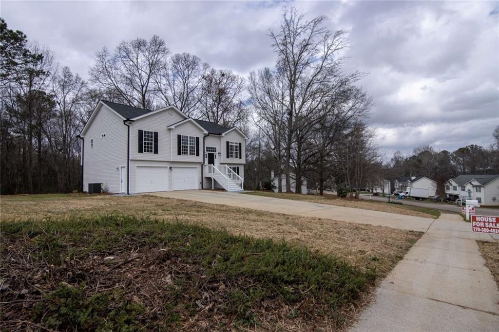 824 Eastmont Road Winder, GA 30680 - Photo 17 of 35 a front view of a house with a yard and garage