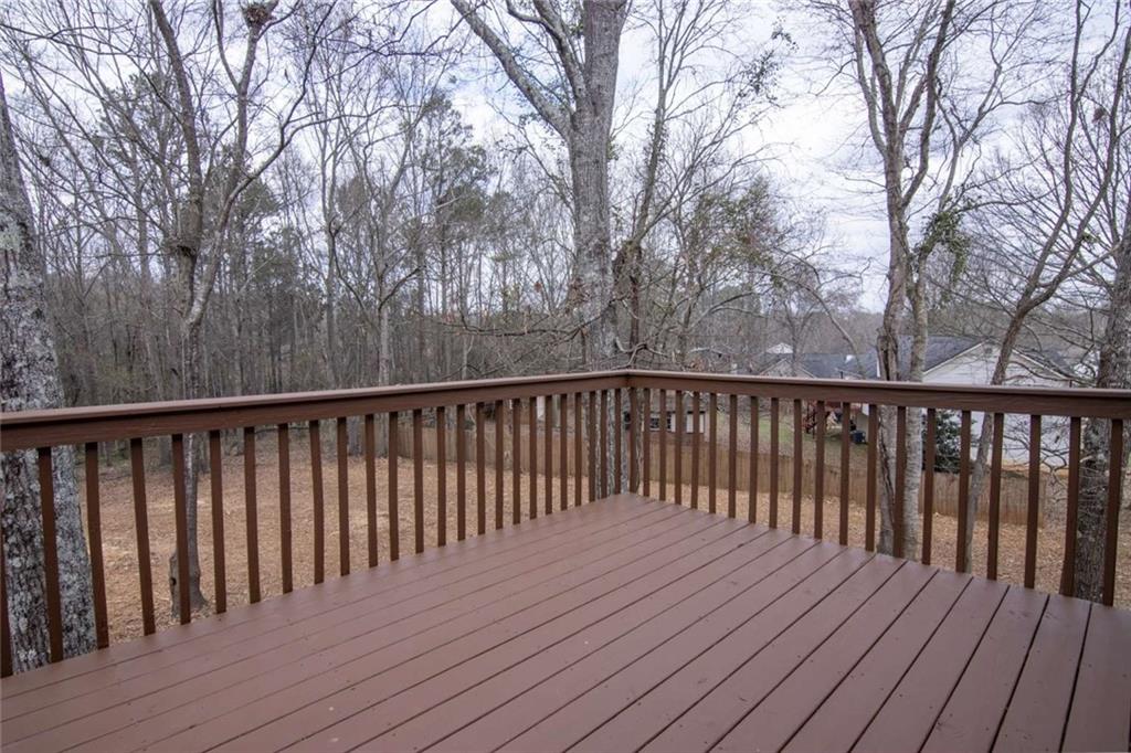 824 Eastmont Road Winder, GA 30680 - Photo 19 of 35 a balcony with wooden floor and trees