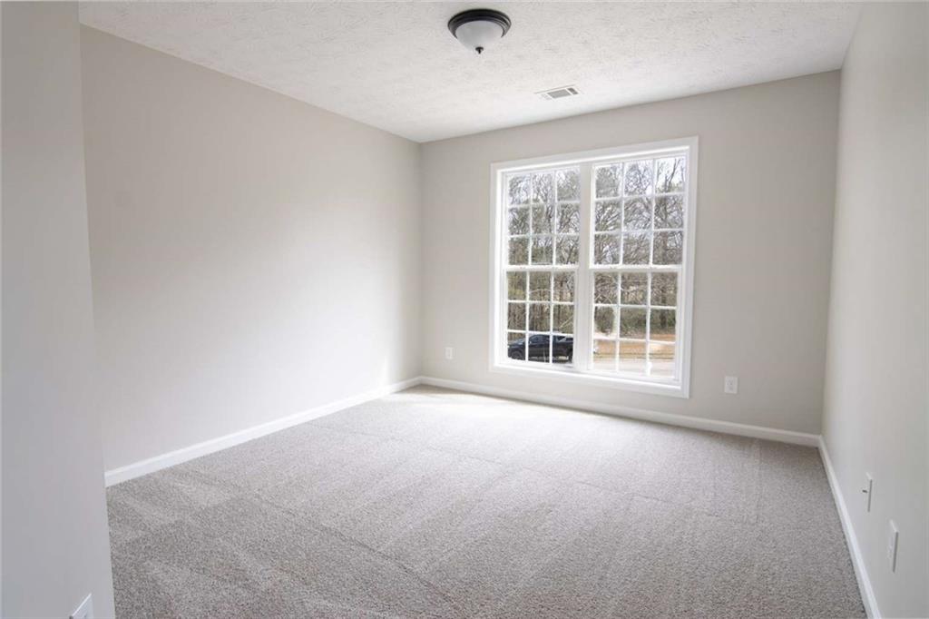 824 Eastmont Road Winder, GA 30680 - Photo 22 of 35 a view of an empty room with a window