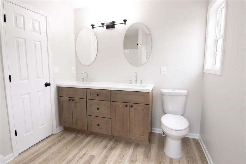 824 Eastmont Road Winder, GA 30680 - Photo 26 of 35 a bathroom with a toilet sink and mirror