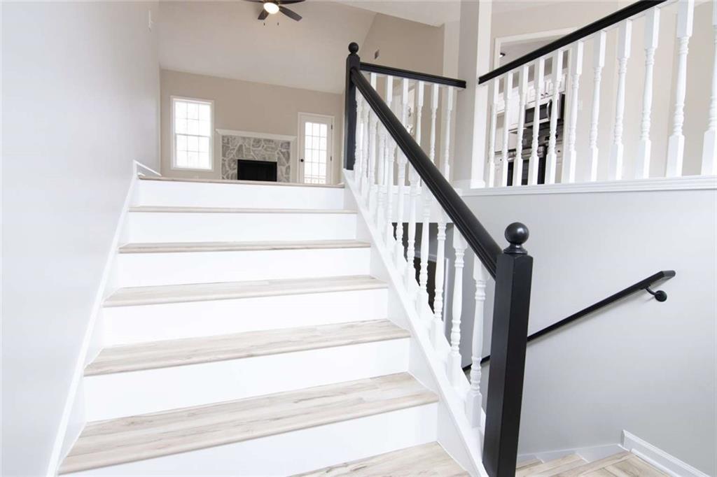 824 Eastmont Road Winder, GA 30680 - Photo 30 of 35 a view of staircase with white walls and a table