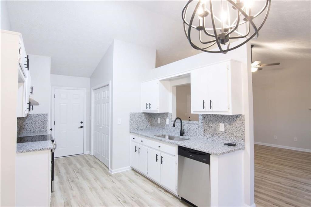 824 Eastmont Road Winder, GA 30680 - Photo 4 of 35 a bathroom with a granite countertop sink a mirror and a shower