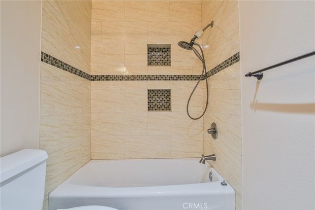 an empty room with wooden floor and a window