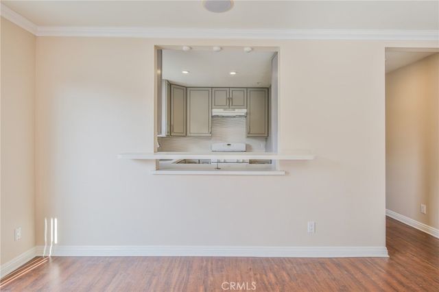 a view of a room with wooden floor