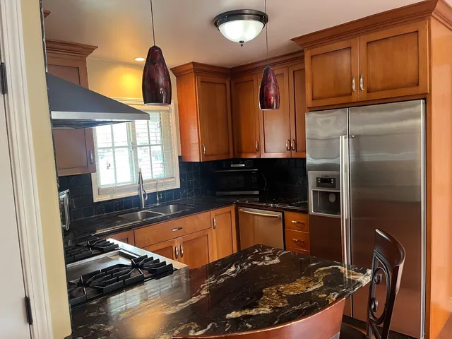 a kitchen with a sink stove and refrigerator