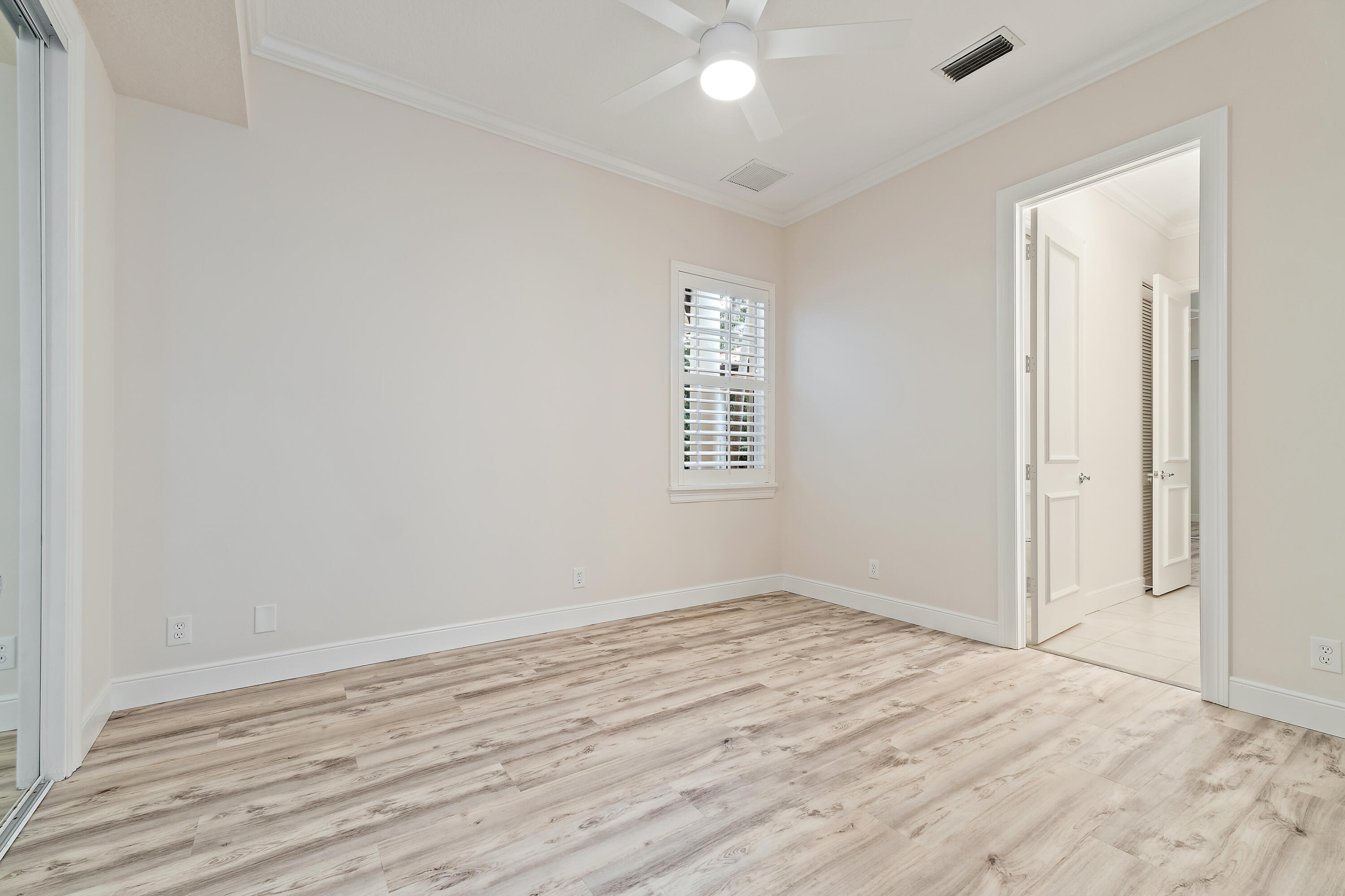 111 Fishermans Way Jupiter, FL 33477 - Photo 36 of 57 an empty room with wooden floor and windows