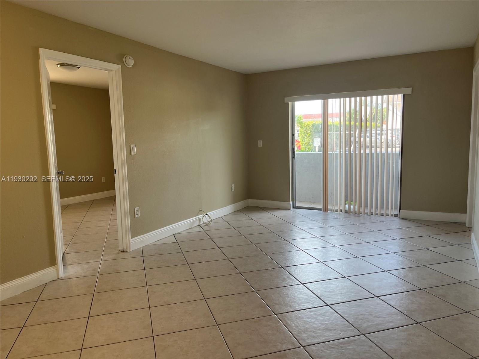 6091 West 22nd Court, Unit 101 Hialeah, FL 33016 - Photo 3 of 15 Living with balcony access