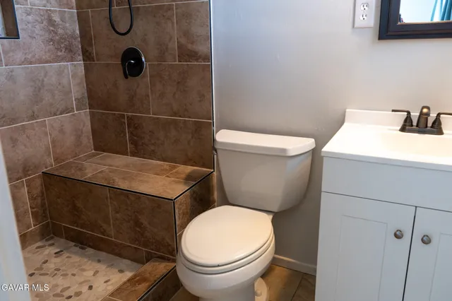 a bathroom with a toilet and a shower