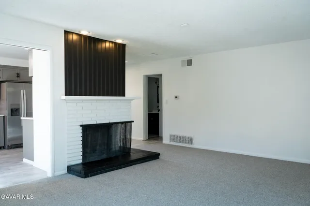a living room with a fireplace and a fireplace