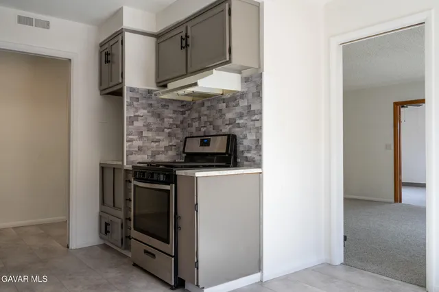 a kitchen with stainless steel appliances granite countertop a stove and a refrigerator
