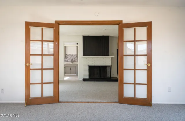 a living room with a fireplace and a window