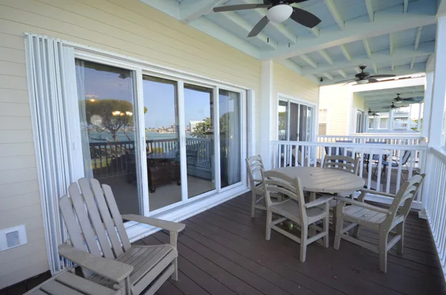 a view of a porch with furniture and wooden floor