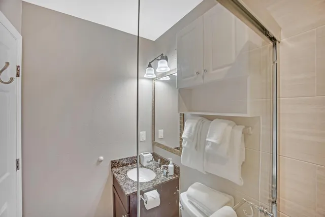 a bedroom with a bed and a flat tv screen on dresser