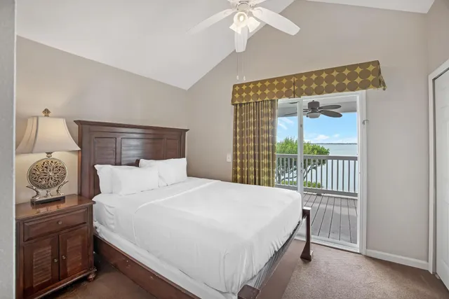 a bedroom with a large bed and a flat tv screen on dresser