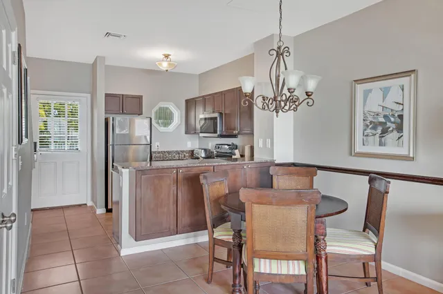 a view of a dining room with furniture and chandelier