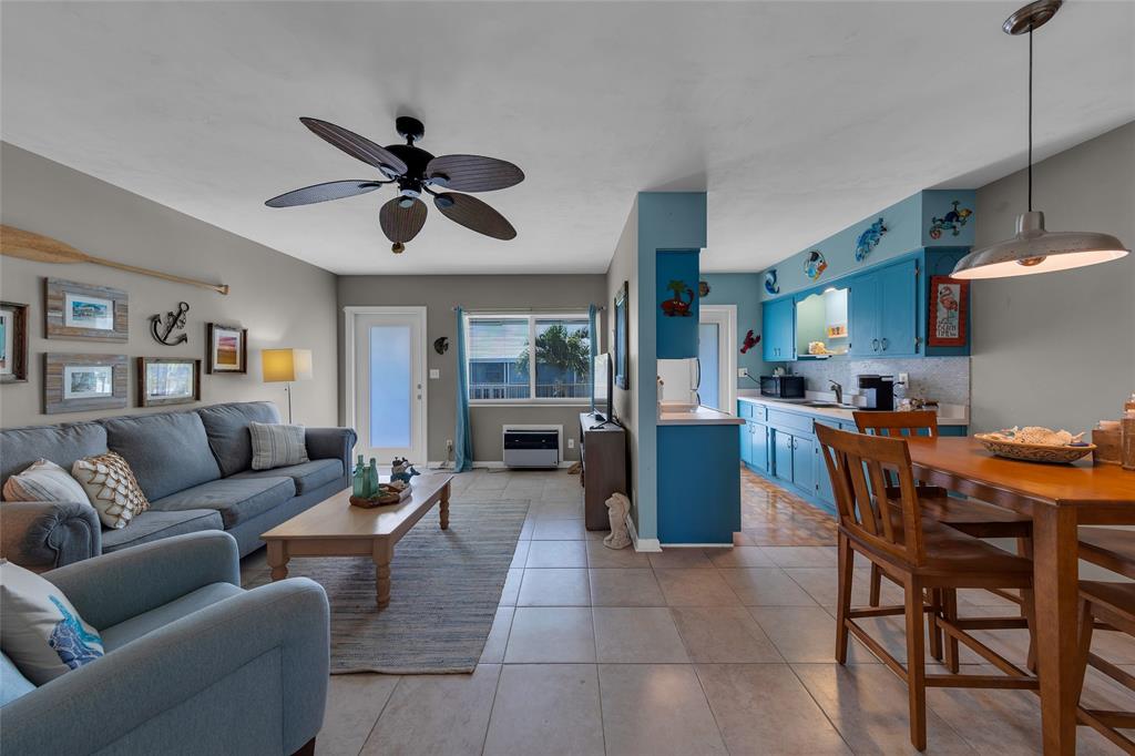 a living room with furniture a dining table and kitchen view