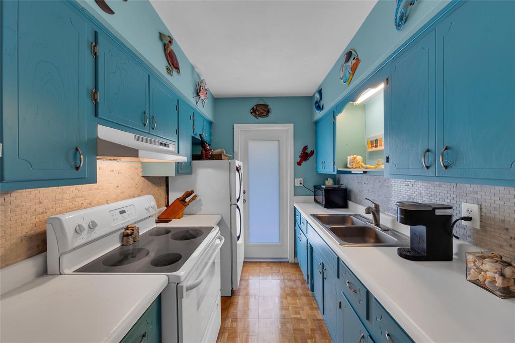 11 Southwest 4th Avenue, Unit 11 Boca Raton, FL 33432 - Photo 15 of 39 a kitchen with a sink a stove and refrigerator
