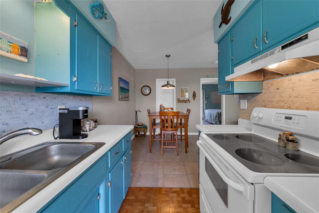 11 Southwest 4th Avenue, Unit 11 Boca Raton, FL 33432 - Photo 17 of 39 a kitchen with a sink stove and cabinets