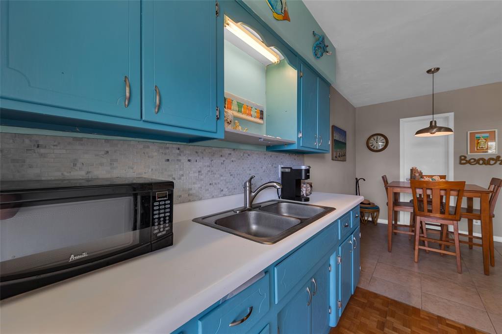 11 Southwest 4th Avenue, Unit 11 Boca Raton, FL 33432 - Photo 18 of 39 a kitchen with granite countertop a sink a stove and cabinets