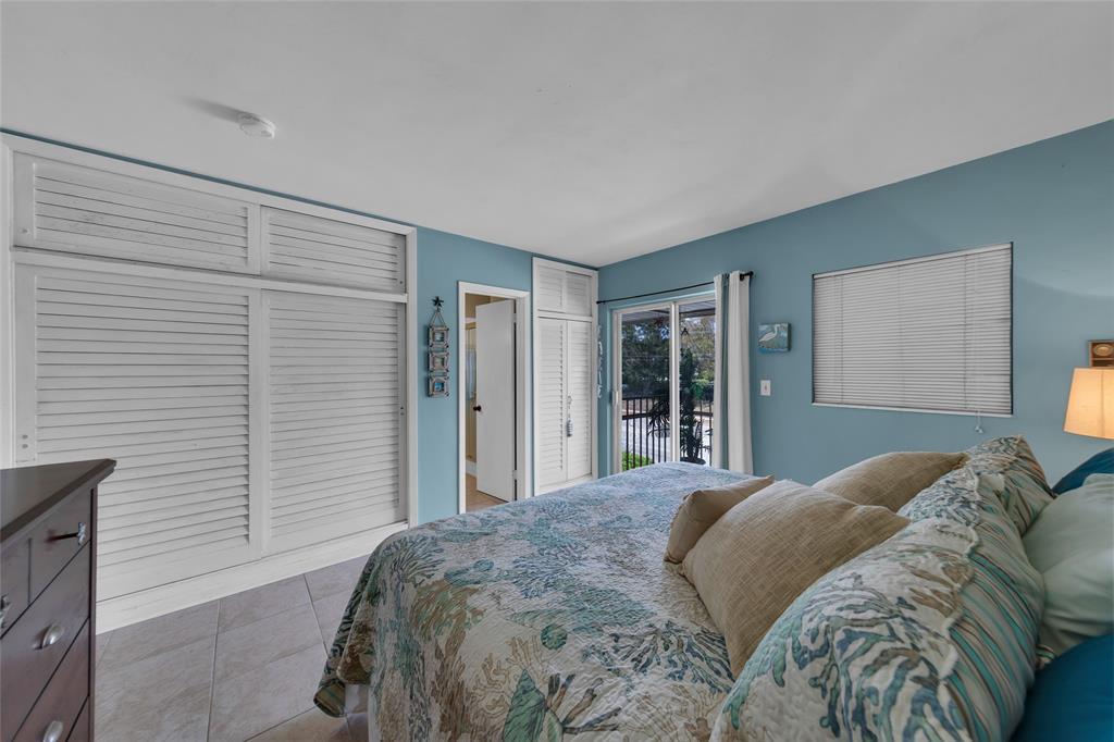 11 Southwest 4th Avenue, Unit 11 Boca Raton, FL 33432 - Photo 20 of 39 a bedroom with a large bed and a window