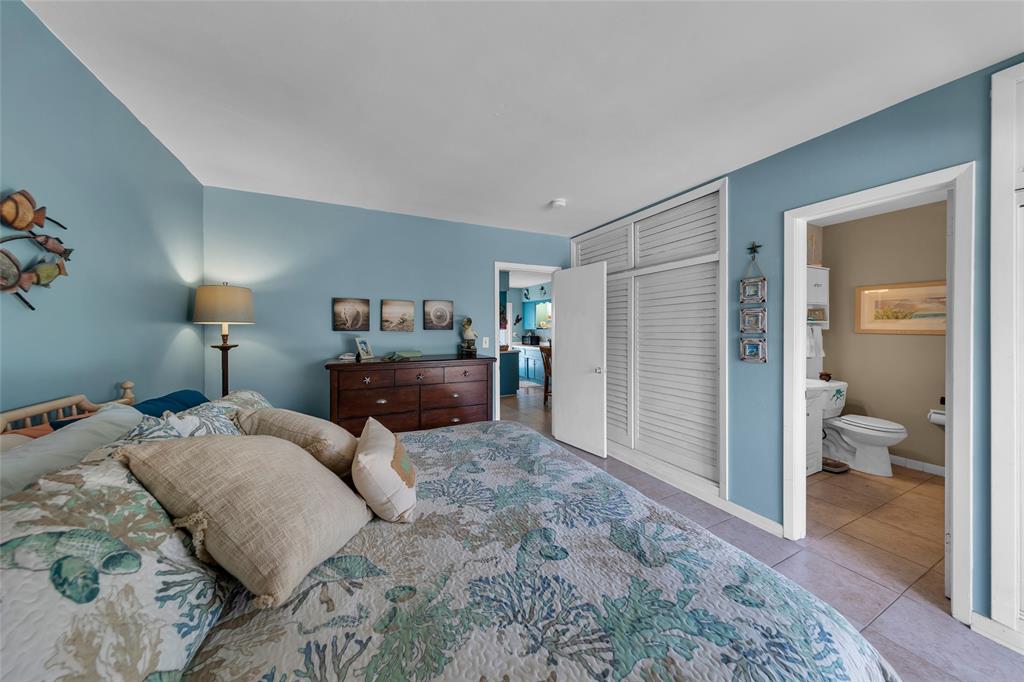 11 Southwest 4th Avenue, Unit 11 Boca Raton, FL 33432 - Photo 22 of 39 a bedroom with bed and walk in closet