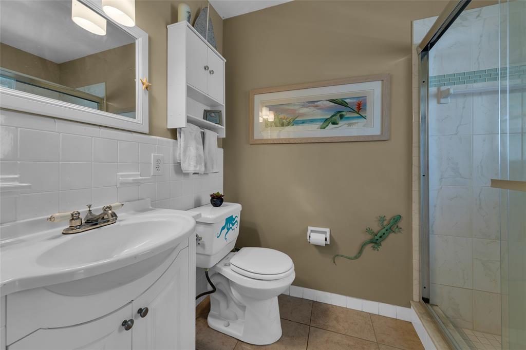 11 Southwest 4th Avenue, Unit 11 Boca Raton, FL 33432 - Photo 23 of 39 a bathroom with a sink a toilet and a mirror