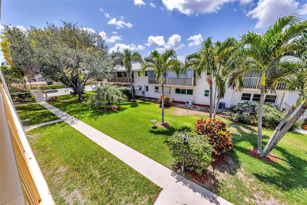 11 Southwest 4th Avenue, Unit 11 Boca Raton, FL 33432 - Photo 31 of 39 a view of a garden with a building in the background