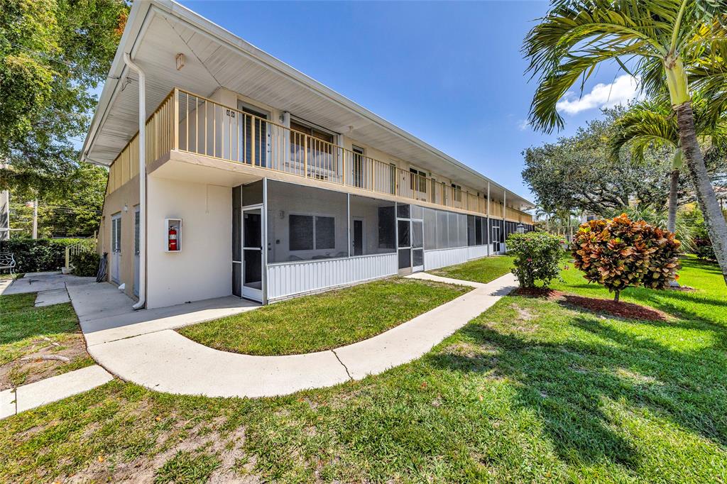 11 Southwest 4th Avenue, Unit 11 Boca Raton, FL 33432 - Photo 32 of 39 a view of a white house with a yard and plants