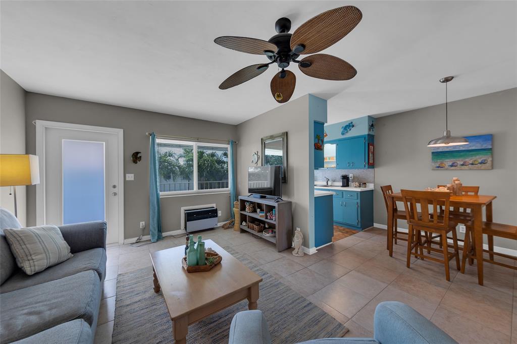 11 Southwest 4th Avenue, Unit 11 Boca Raton, FL 33432 - Photo 8 of 39 a living room with furniture a dining table and a fireplace