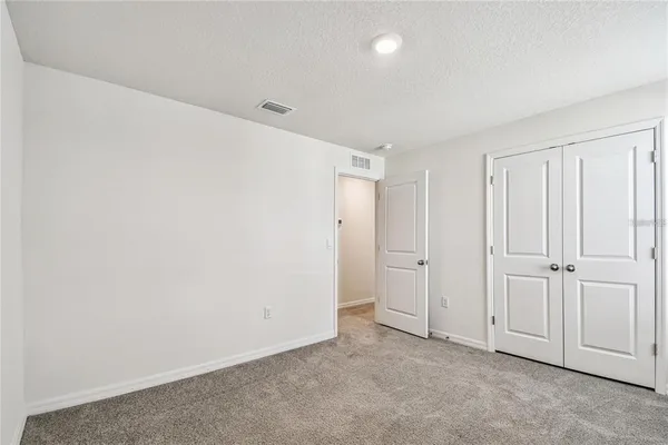 an empty room with closet area