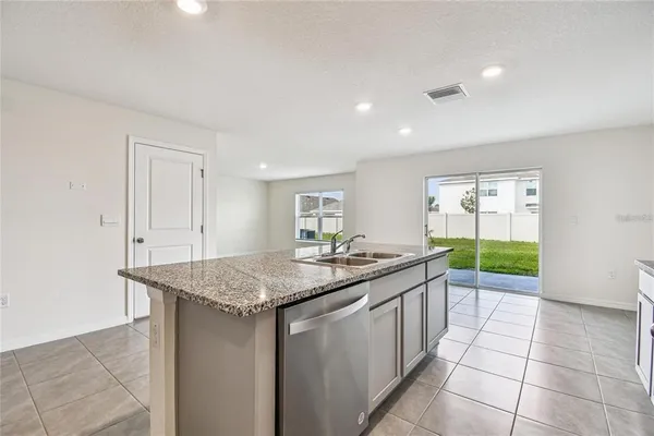 a kitchen with a sink a counter top space and appliances