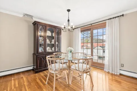 a view of a dining room with furniture wooden floor and windows