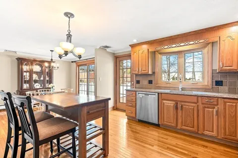 a large kitchen with a table and chairs