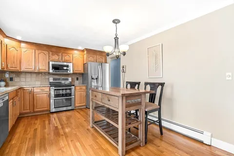 a kitchen with stainless steel appliances a stove a refrigerator and a microwave