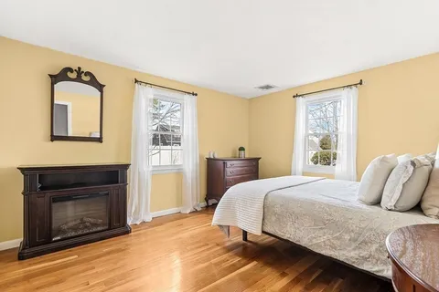 a bedroom with a bed and a fireplace