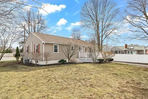 a view of a house with a yard covered in snow