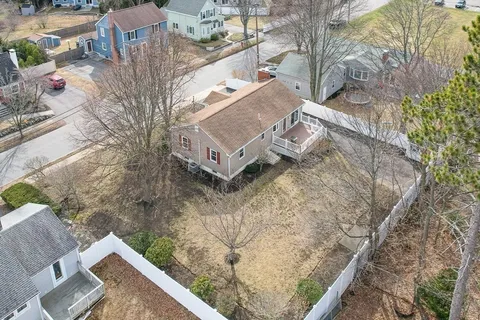 a view of a backyard with wooden fence
