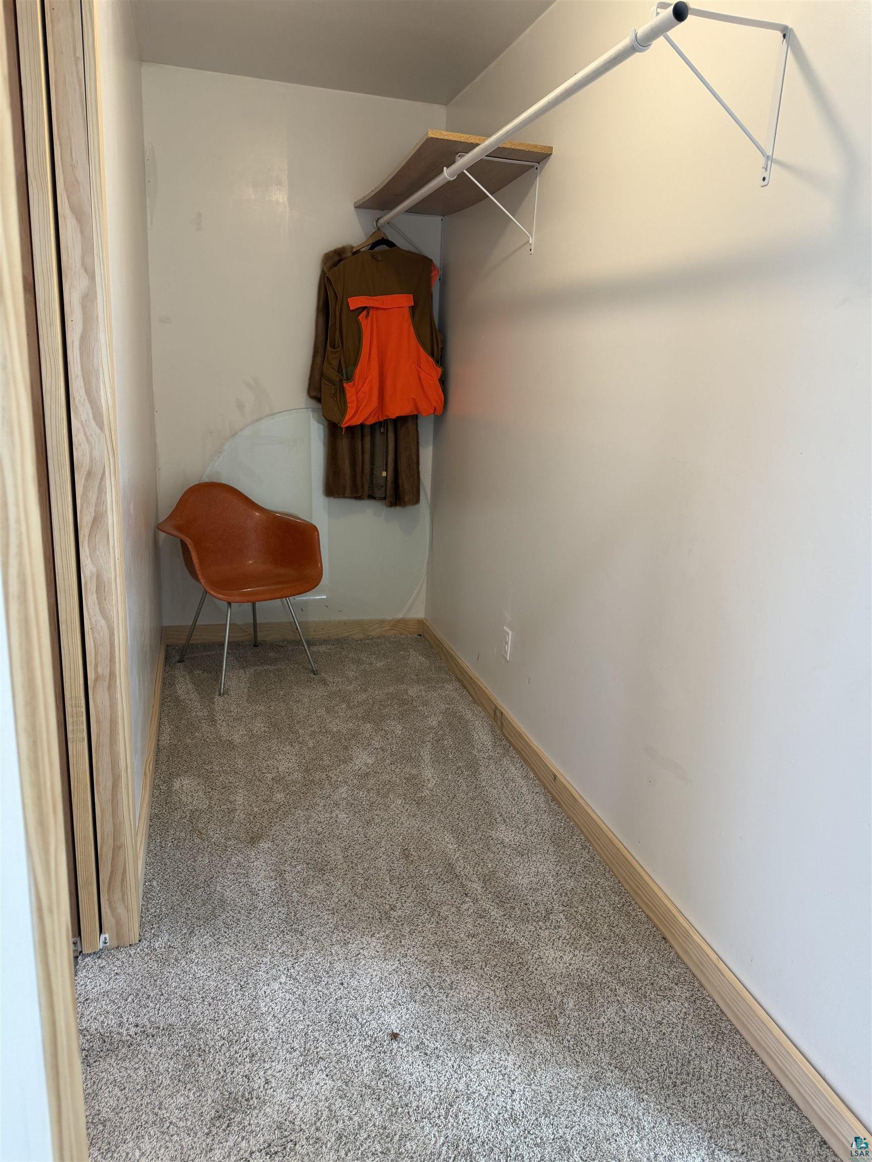 5274 Marble Lake Road Two Harbors, MN 55616 - Photo 34 of 79 Carpeted walk-in closet featuring a built-in hanging rod and wall-mounted shelving