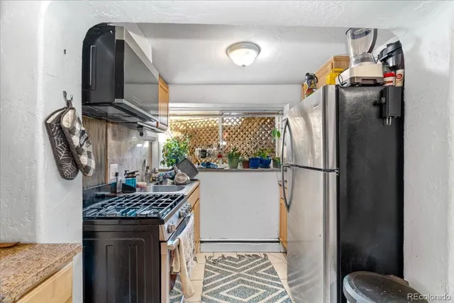 a kitchen with refrigerator and washer