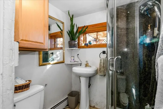 a bathroom with a sink toilet and a mirror
