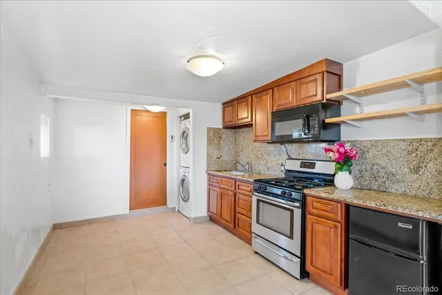 a kitchen with stainless steel appliances granite countertop a stove and a refrigerator