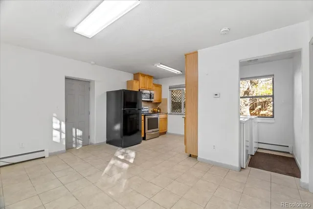 a kitchen with stainless steel appliances a refrigerator and a stove top oven