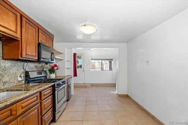 a kitchen with stainless steel appliances granite countertop a sink and cabinets