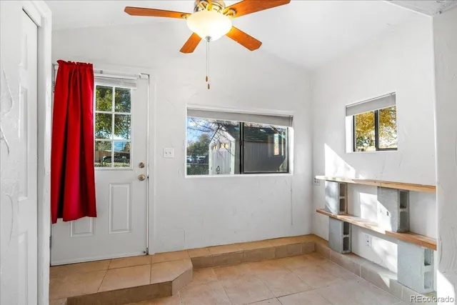 a view of a bedroom with a window and cabinet