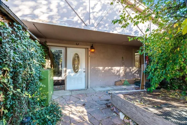 a view of a patio with table and chairs and potted plants