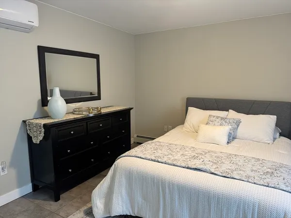a bedroom with a bed and a mirror