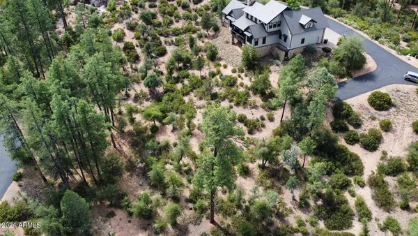 an aerial view of a house with a yard and parking spaces